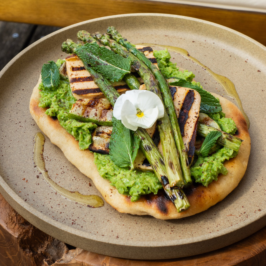 Amalie Sigrid's recipe for grilled flatbread with pea purée, halloumi, and greens